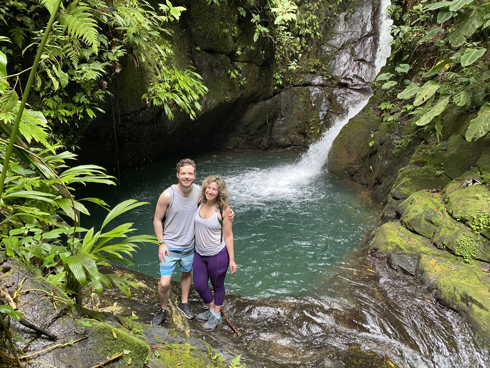 Couple next to a Waterfall, Hacienda Ébano, a Nature Reserve and Farm with Rainforest and Waterfalls at Barú, Costa Rica