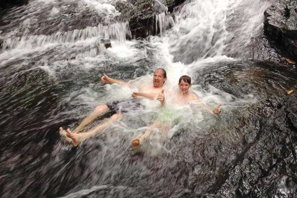 Family playing in the river at the Natural Reserve of Hacienda Ebano - near Dominical - Baru Costa Rica